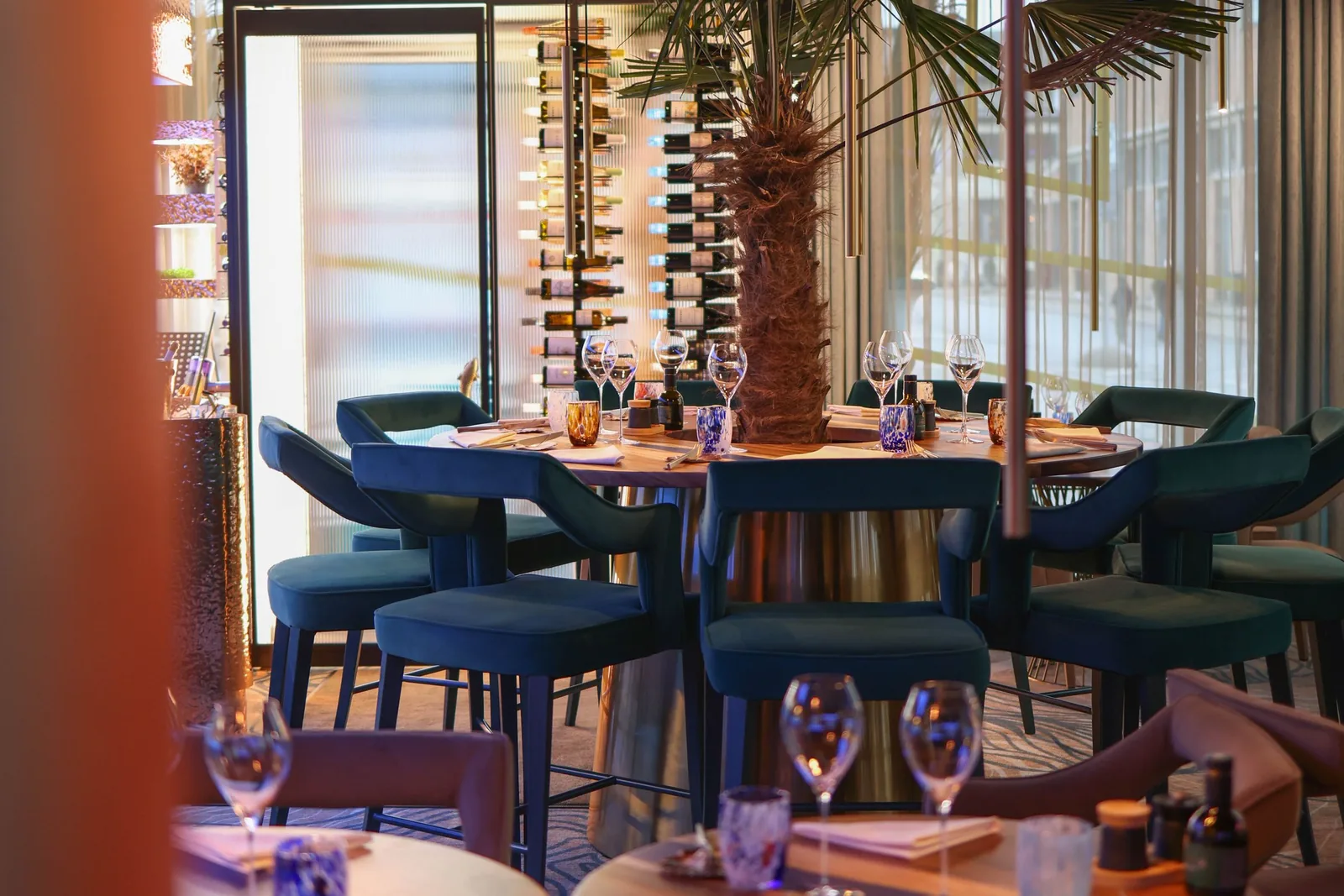Elegant restaurant dining interior with warm ambient lighting and place settings